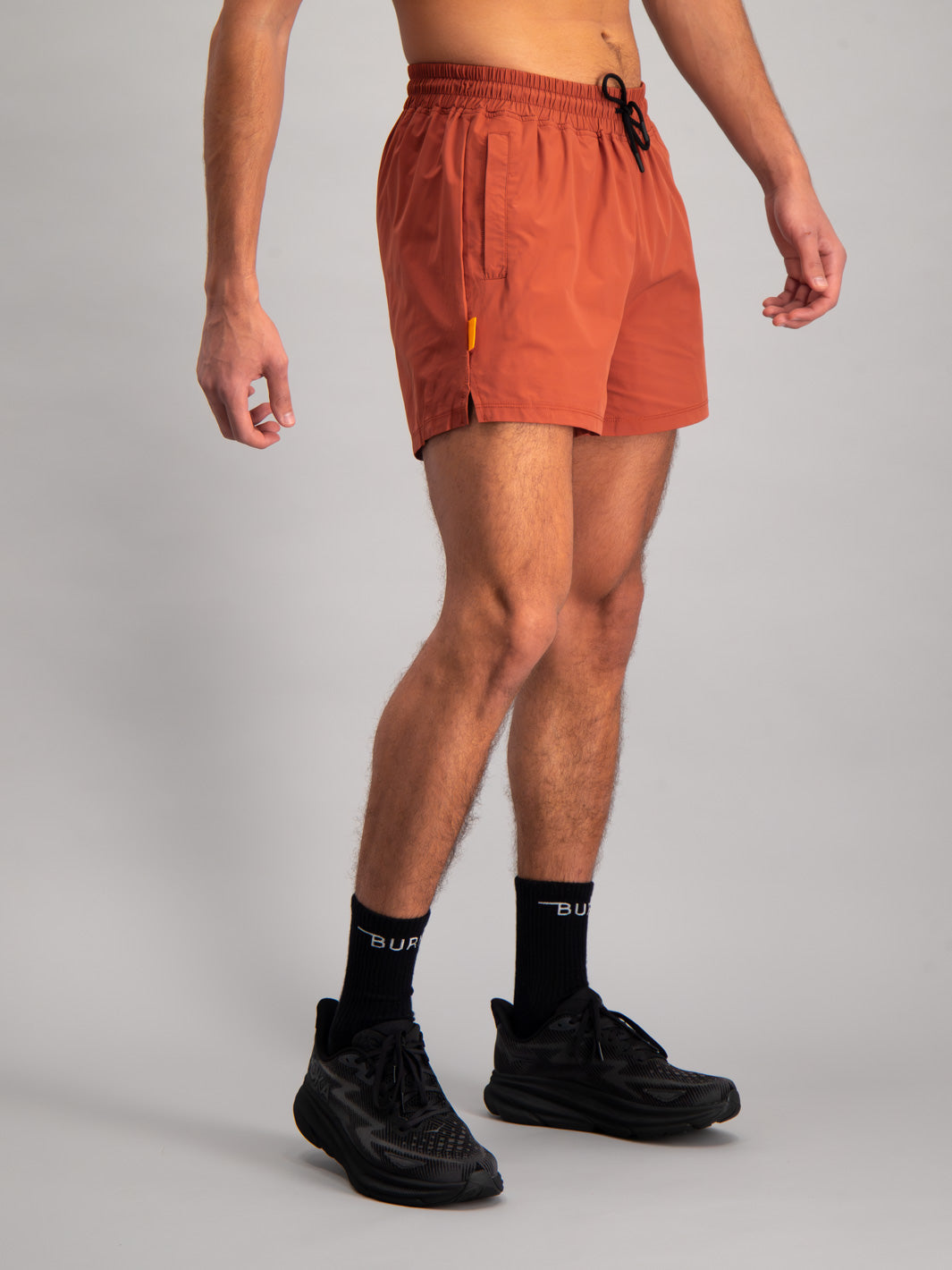 Burnt Studios Activewear 5-inch shorts in core rust side